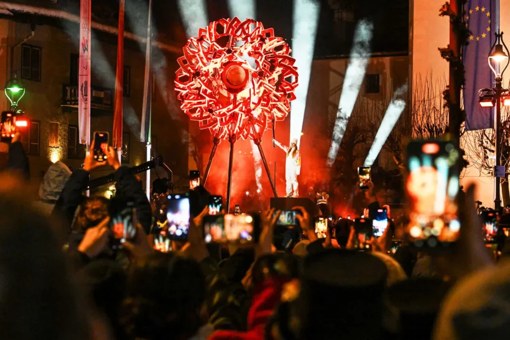 Athletes parade at four sites in italy to kick off winter olympics